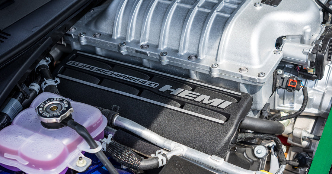 A 2023 SRT Hellcat with a supercharged Hemi engine with the hood up for a clear view of the internals.