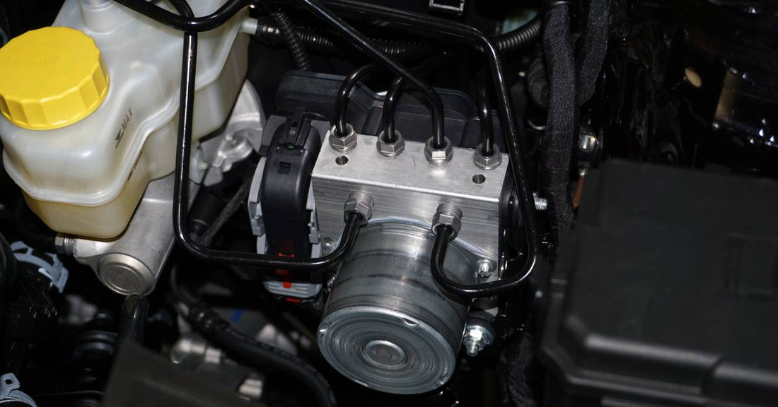 A close-up of the interior of a modern car engine, showcasing the anti-locking braking system actuator and pump assembly.