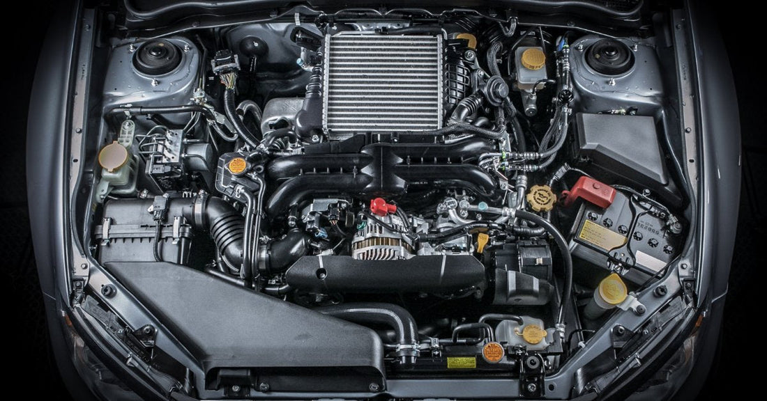 A vehicle’s hood is open and revealing the engine inside. There are multiple components within the engine.